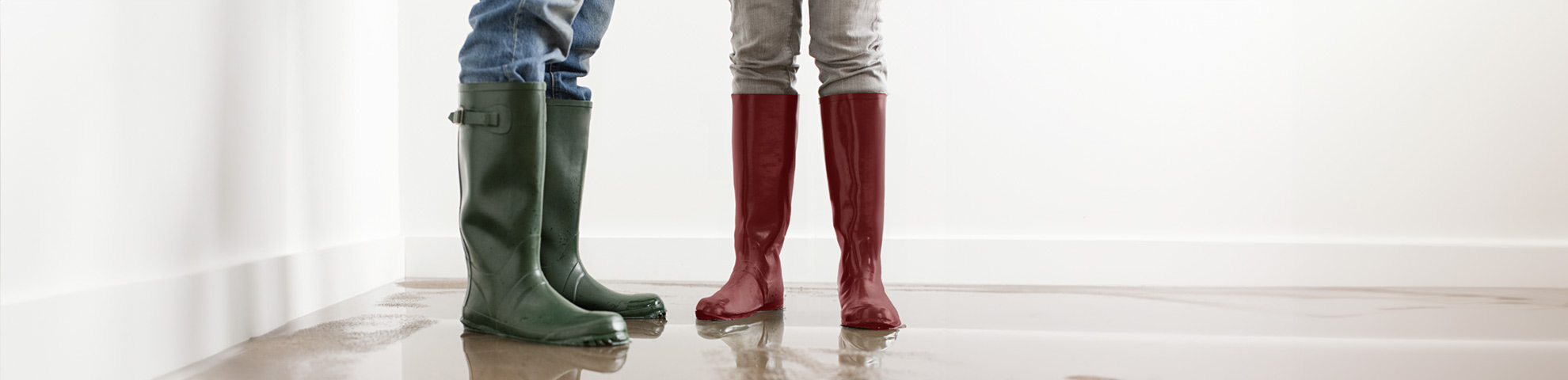 Deux personnes qui portent des bottes dans une pièce après un sinistre