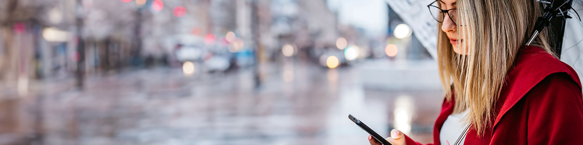 Une femme dans la rue qui regarde son téléphone
