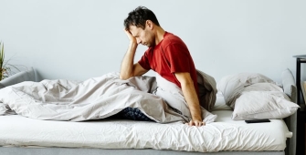 Un homme dans son lit en manque de sommeil