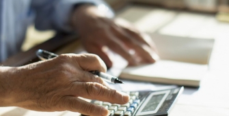 photos des mains d'un homme effectuant des calculs