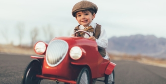 Un enfant qui conduit une mini voiture