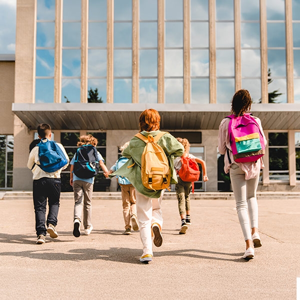 des enfants qui courent vers l'école